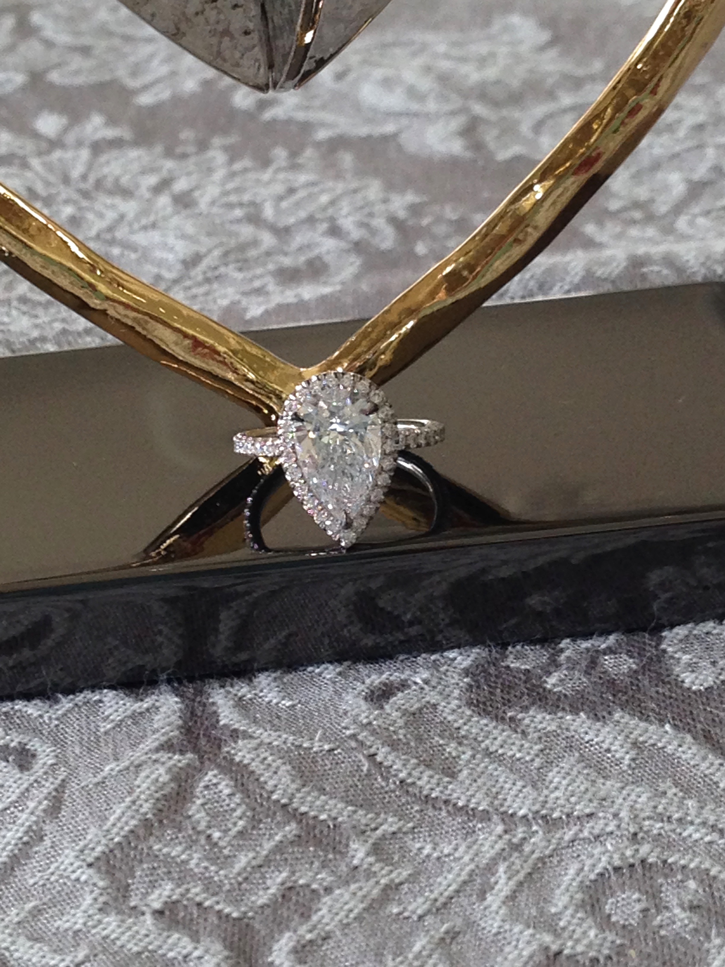 Pear diamond engagement ring with diamond halo