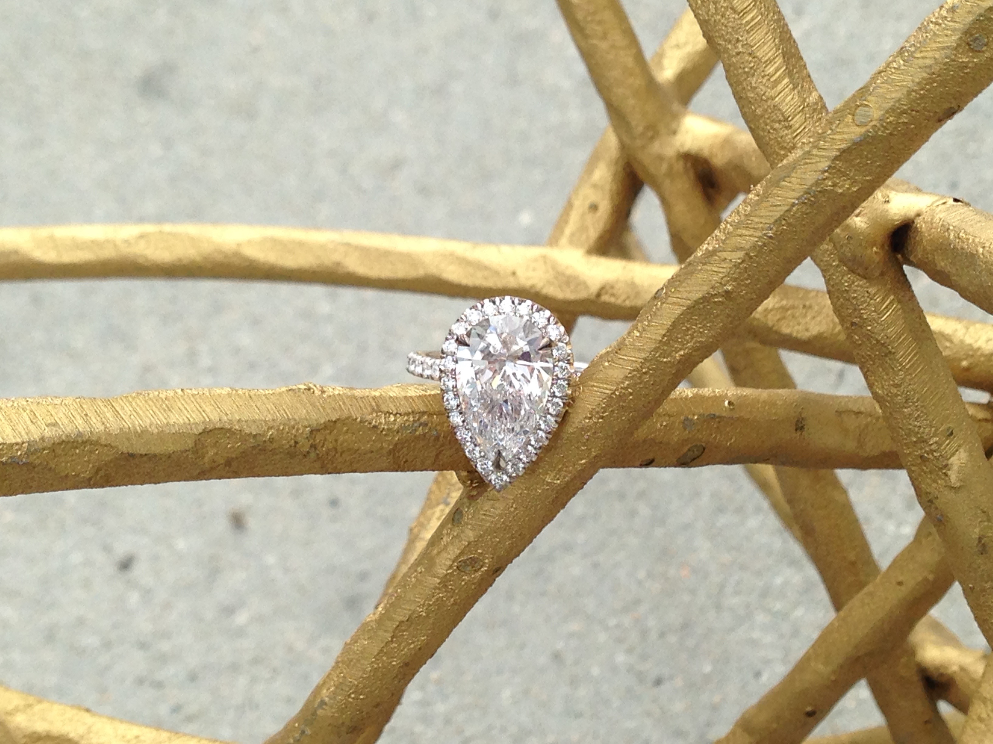 Pear diamond engagement ring with diamond halo